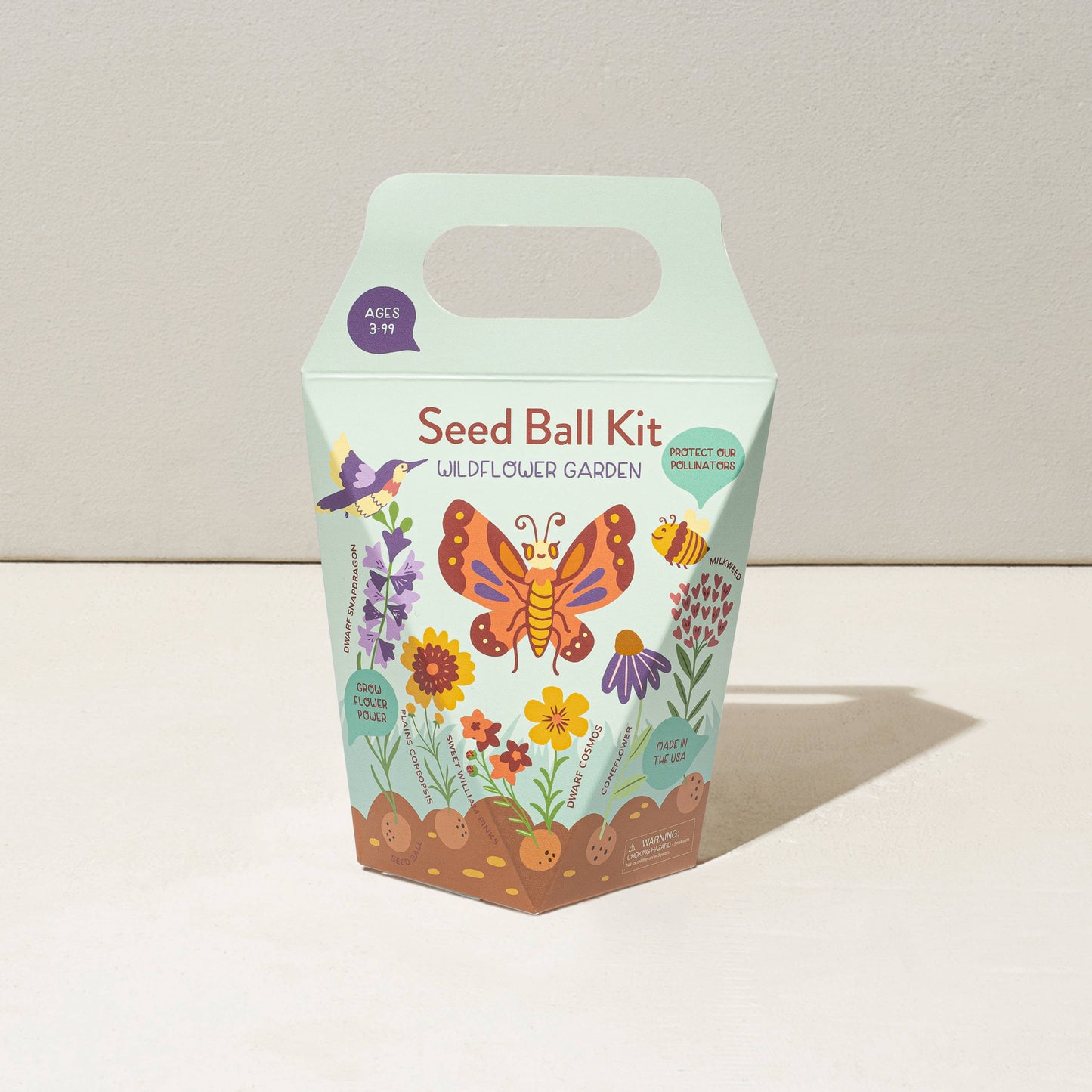 Seed ball kit packaging with butterfly and flower illustrations on a light background