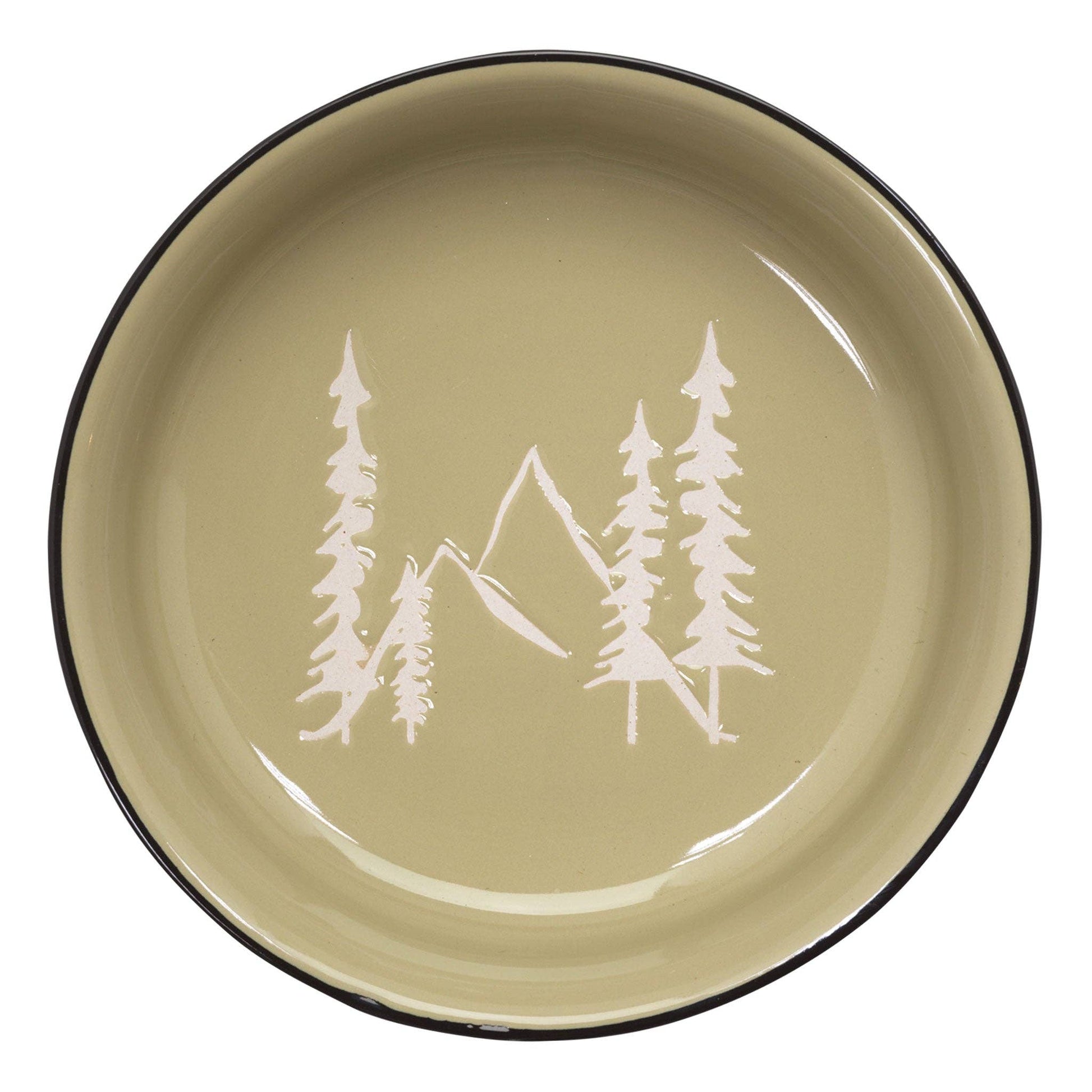 Round plate with mountain and tree design on a green background