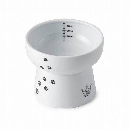 White ceramic raised bowl with black paw prints and volume markings on a white background