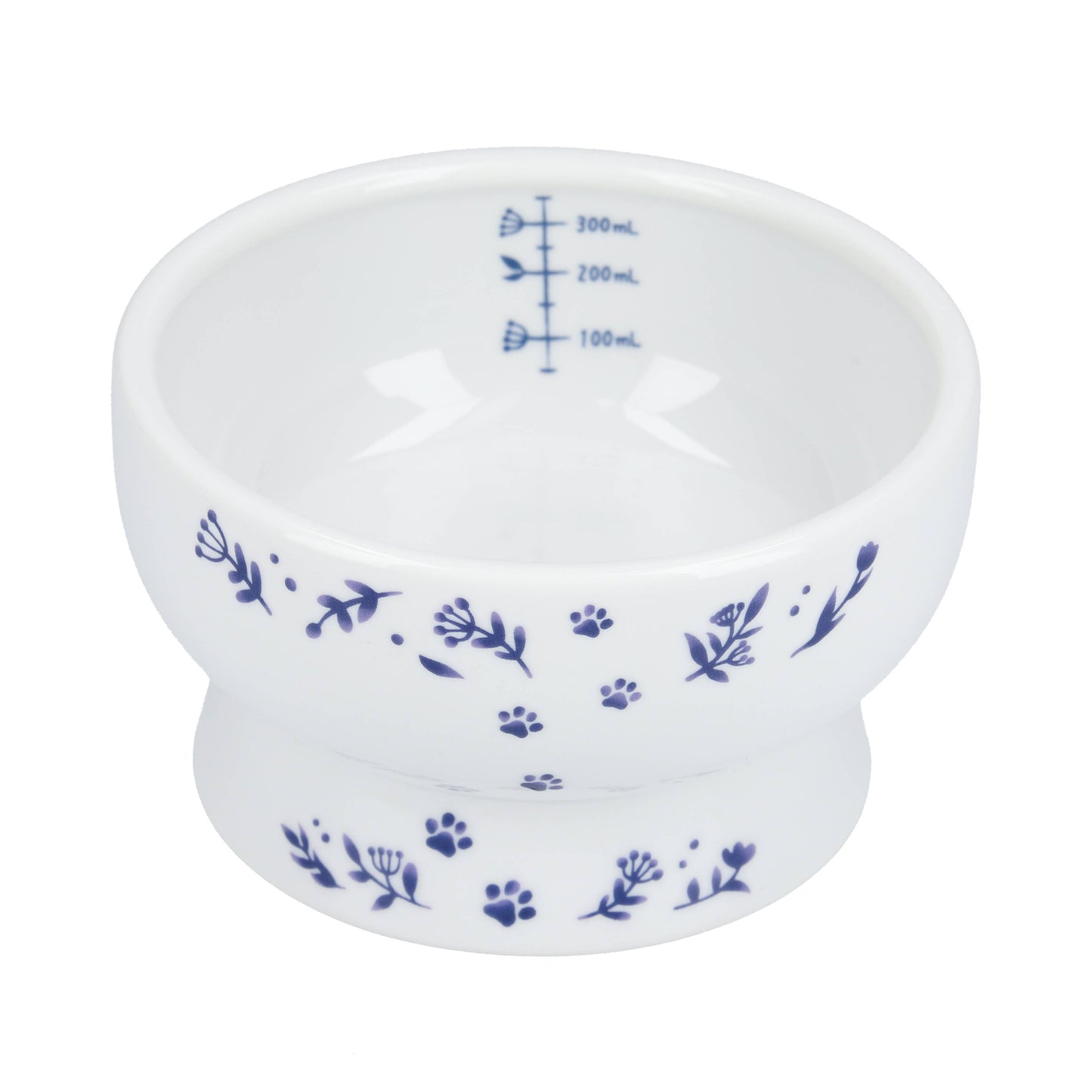 White measuring cup with blue floral and paw print designs on a white background