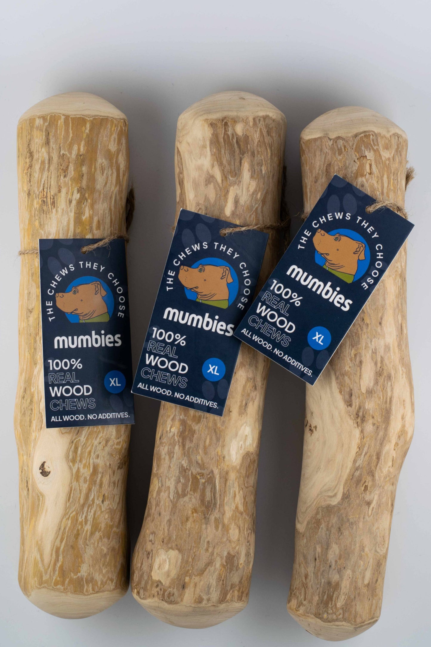 Three wooden chew toys with 'mumbies' labels on a white background